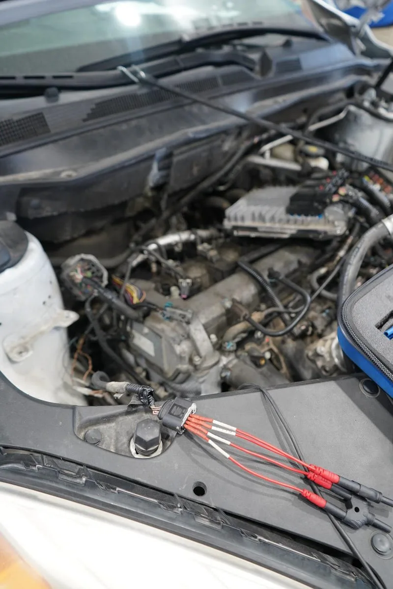 Electrical test leads connected in an engine bay for circuit diagnosis at Auto Tech Services