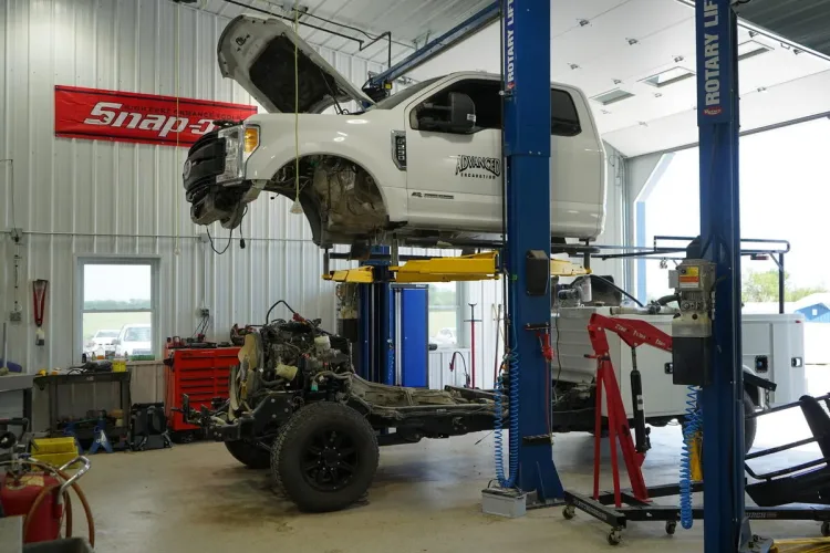 Ford diesel truck on lift with cab separated from frame